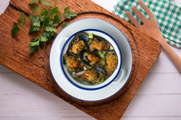 Wall Mural - Mussels au gratin with parsley, oil and bread. Top view table with decorations.