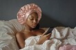 © Vlad - Bonnet Portrait: Young African American Girl Relaxing on Bed with Phone