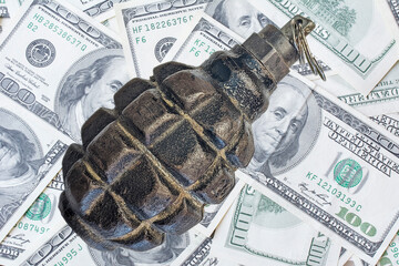 Hand grenade on money background