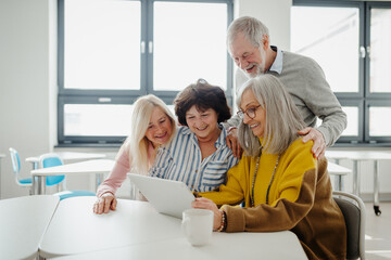 Sticker - Group of senior students looking at tablet screen, learning new skill. Elderly people attending computer and technology education class. Digital literacy.