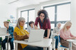 © Halfpoint - Teacher explaining senior students how to start their own business. Elderly people attending computer and technology education class. Entrepreneurship program for seniors.