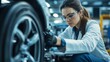 © IMAGINIAC - Female Automotive Engineer Inspecting Car Wheel in Factory