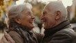 © IMAGINIAC - Elderly couple laughing and embracing outdoors