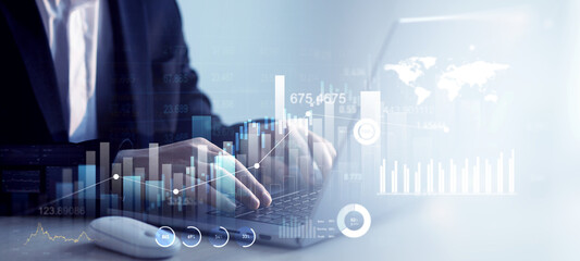 Leinwandbilder - Businessman using laptop with digital screen of analyzing data sales and financial graph chart. Business development strategy,analysis and planning.