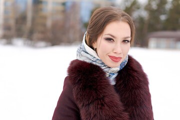 Wall Mural - A woman wearing a red fur coat and a scarf