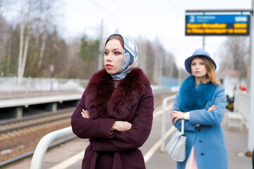 Wall Mural - Two women are standing at a train station