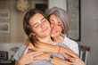 © ADDICTIVE STOCK - Mother and teenage daughter sharing a loving embrace at home
