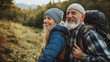© ANDREI - Loving mid aged couple with a backapacks hiking on the hills together