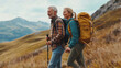 © ANDREI - Loving mid aged couple with a backapacks hiking on the hills together