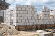 © ilyaska - Building walls with aerated concrete blocks on construction site