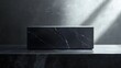 © ninakosh - Elegant black marble block on a dark surface illuminated by soft light in a minimalist setting
