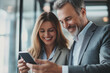 © Patcharaphon - Smiling business people using a mobile phone while talking together. Technology, lifestyle concept