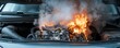 © MNFTs - A close-up view of a car engine on fire, emitting smoke and flames, depicting a dangerous automotive situation.