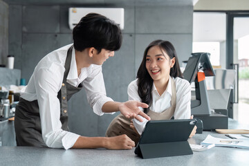 Wall Mural - young entrepreneurs discussing business strategy in modern office setting with digital tablet