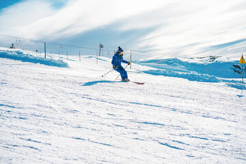 Wall Mural - Young man athlete skiing in snow mountain - Skier riding down for winter sport competition - Travel and vacation concept - Focus on his face