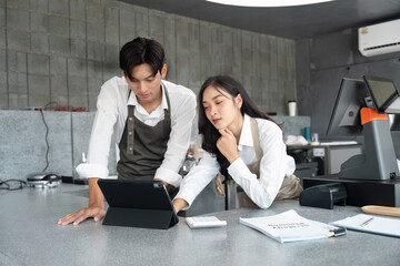 Wall Mural - young entrepreneurs working on a digital tablet in a modern small business setting