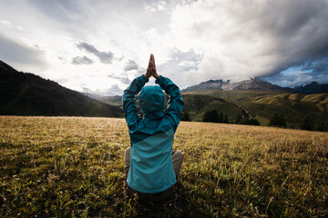 Poster - Woman hiker meditation on the high altitude mountain top grassland