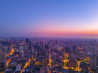 Aerial view of modern city skyline and buildings at sunrise in Shanghai