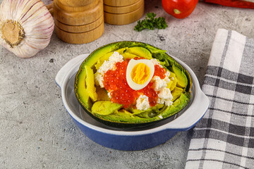 Avocado with red caviar and quil egg