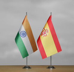 Table flags of Spain and India on grey blurred background