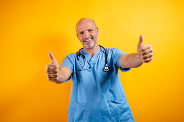 A happy bald doctor is smiling, wearing a stethoscope and exuding a positive, confident attitude.