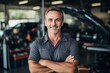 © Vorda Berge - Smiling portrait of a middle aged Caucasian car mechanic in workshop