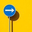 © Jittiwan - A blue round street sign post with arrow sign on it standing on yellow background