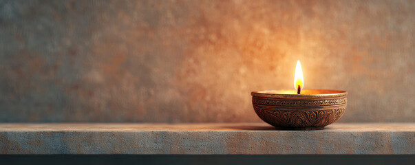 beautifully carved brass diya placed on wooden shelf, radiating warm glow. flickering flame creates serene atmosphere, perfect for meditation or celebration