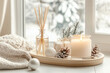 © barmaleeva - Warm scene with a lit candle and reed diffuser