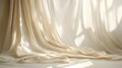 © Jittapon - Elegant fabric drape with soft flowing folds in neutral tones creating a calm and serene studio background perfect for product shots fashion photography or minimalist design