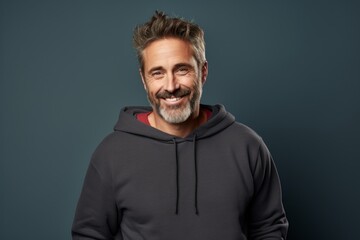 Poster - Portrait of a merry man in his 40s dressed in a comfy fleece pullover isolated in blank studio backdrop