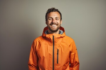 Sticker - Portrait of a happy man in his 30s wearing a windproof softshell isolated in light wood minimalistic setup