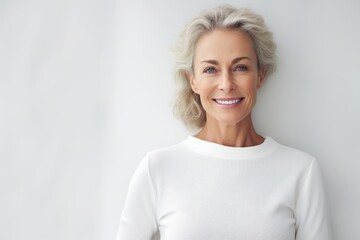 Canvas Print - Portrait of a content woman in her 50s showing off a thermal merino wool top over plain white digital canvas