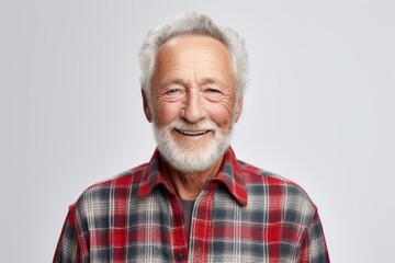 Wall Mural - Portrait of a smiling man in his 70s wearing a comfy flannel shirt isolated on plain white digital canvas