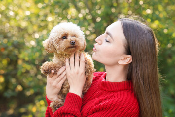 Wall Mural - Portrait of woman with cute dog outdoors