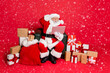 © deagreez - Full body photo of impressed santa claus in hat with eyewear eyeglasses read noel news on his laptop feel stupor isolated over red background