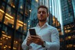 © Visual Odyssey - Businessman using mobile phone app texting outside of office in urban modern city building background. Young caucasian man holding smartphone for business, Generative AI