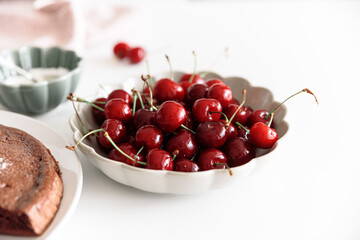 Wall Mural - Tasty cherry pie decorated fresh berries on white table. Summer food concept. Soft focus