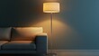 © Lucky_jl - Modern floor lamp illuminating a cozy sofa in a stylish living room with a dark blue wall.
