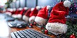 © aicandy - A festive office setup with computers adorned with Santa hats and Christmas decorations, reflecting holiday spirit in a modern workplace environment