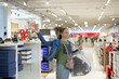 © andov - A girl with a bag in a shopping center looks at things to buy.