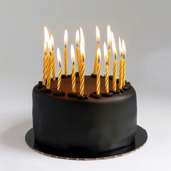 Wall Mural - Black round birthday cake with burning golden candles on white background, closeup	