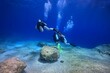 © blue-sea.cz - Group of scuba divers, exploring underwater seascape in the blue ocean.Shallow bay with rocks. Underwater photography from scuba diving exploration trip. Scuba divers in the ocean, travel photo.