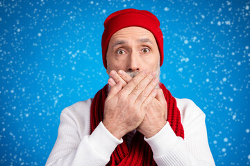 Wall Mural - Photo of puzzled aged man arms palms covering mouth staring camera isolated on blue color background