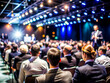 © sanjit536 - Business Conference Speaker Presenting to a Large Audience in a Professional Setting, on dark blue background