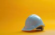 © stock.finder - White construction safety helmet placed on an orange background. Design for poster, banner, and safety campaign.