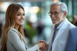 © Image Alchemy - Young business woman shaking hand with elderly doctor, Generative AI