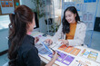 © MINAE - Two asian women working as ui/ux designers collaborating on a new project, developing application prototypes for mobile phone