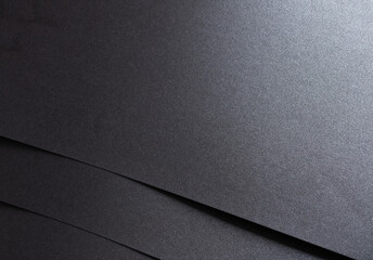 Aufkleber - Black paper with a smooth texture and minimalist, geometric pattern. The monochrome design features clean lines, subtle shadows, and a soft glow, creating a premium, luxury