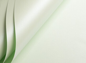Wall Mural - Paper with a rich texture and glowing gradient in pale green and frosted mint tones. The minimalist, monochrome surface features delicate folds and layered lines, creating a subtle